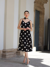 a lady wears a polka dots printed spaghetti strap midi dress